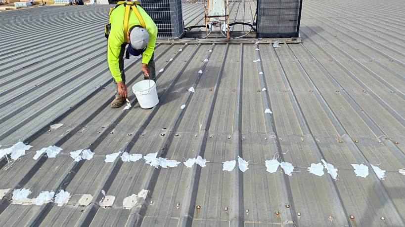 Applying Mastic and Silicone Coating to a Metal Roof at Little Caesars, Troy, AL