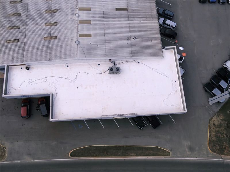 Aerial view of the newly installed Duro-Last 50-Mil Low-Slope PVC Roof System at the Ed Sherling Ford Dealership in Enterprise, Alabama. Restoration Commercial Roofing Services completed this project to full manufacturer standards, achieving NDL certification for 20 years of leak-free performance.