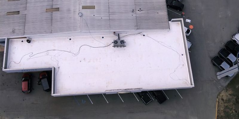 Aerial view of the newly installed Duro-Last 50-Mil Low-Slope PVC Roof System at the Ed Sherling Ford Dealership in Enterprise, Alabama. Restoration Commercial Roofing Services completed this project to full manufacturer standards, achieving NDL certification for 20 years of leak-free performance.